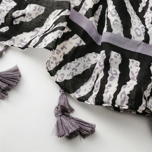 Detail of purple zebra print scarf showing tassels and light breathable fabric texture
