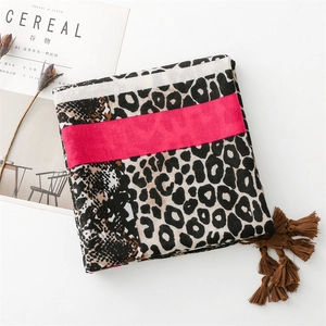 Detailed view of leopard print cotton linen scarf with soft tassels and pink patchwork