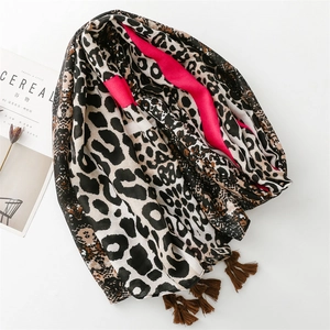 Soft leopard print scarf with pink edges and brown tassels on a clean white background