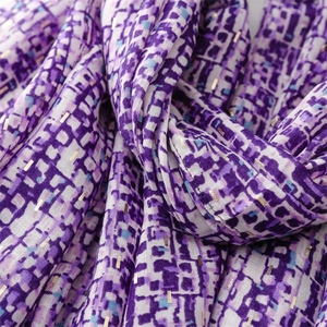 Detail of purple pixelated pattern shawl with subtle gold metallic foil highlights