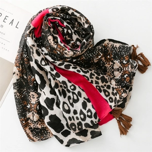 Detail of red and leopard print scarf with soft fringe edges on white background