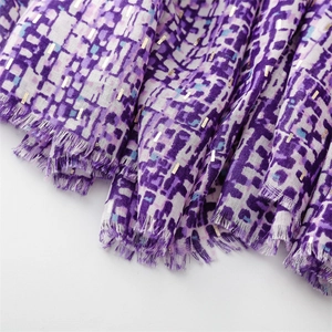 Detailed close-up of purple geometric print scarf with gold sequins and fringe