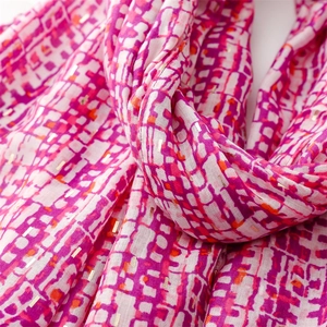 Detail of pink and purple geometric scarf with gold foil accents and soft texture
