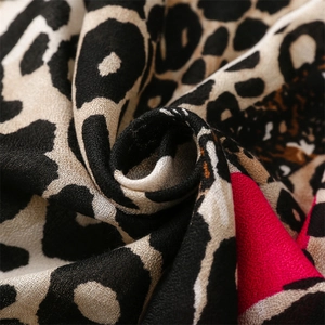 Detailed close-up of pink leopard print scarf showing soft cotton-linen texture and weaving