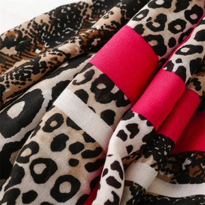 Close-up of soft cotton-linen scarf fabric with leopard print and pink stripes