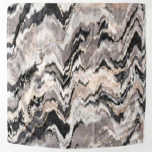 Detail of cotton-linen scarf with golden foil hearts and abstract wave pattern design