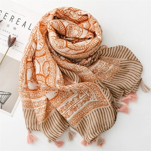 Detail view of ethnic lotus print scarf with elegant fringe tassels and linen texture