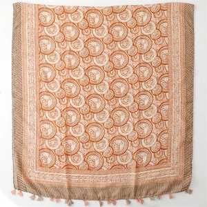 Detail of bohemian scarf with lotus floral patterns and soft tassel fringe edges