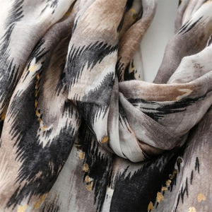 Detail of linen-feel scarf with golden glitter hearts and abstract pattern textures