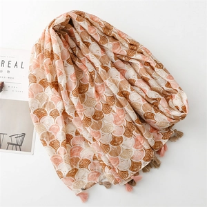 Detail of bohemian scarf featuring seashell patterns and elegant fringe tassels