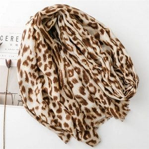 Close-up of leopard print scarf with fine fringe edges and soft linen-feel texture