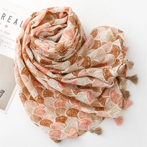 Close-up of shell pattern cotton linen scarf with elegant tassel trim details