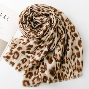 Detail of leopard print scarf with gold metallic threads and natural frayed edges