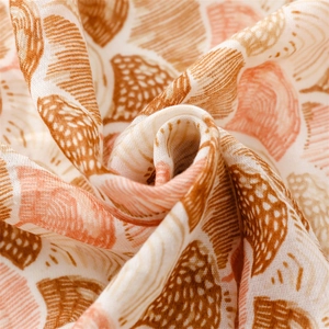Macro shot of cotton linen scarf showing soft texture and brown shell pattern print