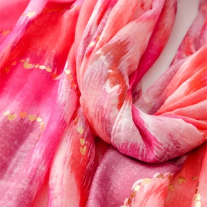 Detail of pink gradient scarf with gold foil heart pattern and soft linen texture