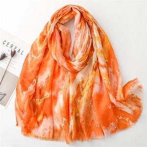 Detail of orange gradient cotton linen scarf with gold foil printing and frayed edges