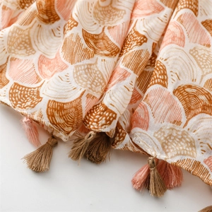 Detail of cotton-linen scarf with scallop prints and dual-tone handmade tassels