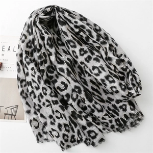 Detail of grey leopard print scarf with fringe edges and soft cotton-linen texture