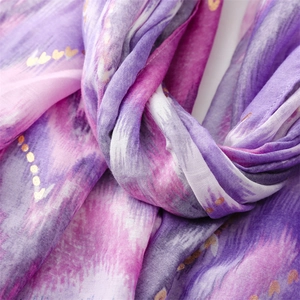 Macro shot of purple gradient scarf with delicate gold heart prints and soft texture