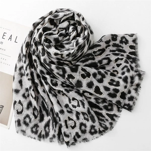 Close-up of leopard print scarf with silver metallic thread and delicate fringe edge