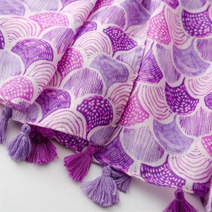 Detailed macro view of purple shell pattern cotton linen scarf with elegant tassel charms