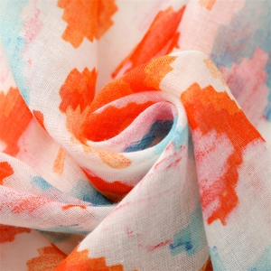 Close-up of lightweight geometric scarf fabric with colorful abstract prints and soft texture