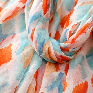 Macro shot of breathable fabric with colorful geometric pattern on a summer scarf shawl