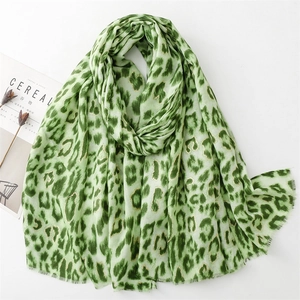 Light green leopard print linen-feel scarf with tassel edges and chic gold foil details
