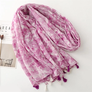 Pink and purple floral scarf wrap with tassels on white background with cereal magazine