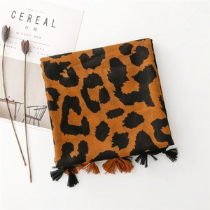 Detailed close-up of leopard print cotton scarf featuring elegant two-tone short tassels