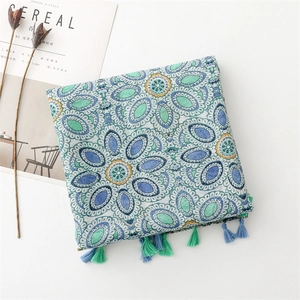 Detail of bohemian mandala scarf with turquoise tassels and ethnic geometric patterns