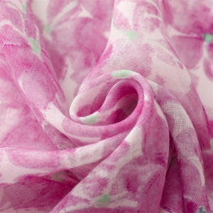 Macro view of lightweight floral scarf showing translucent texture and pink flower print
