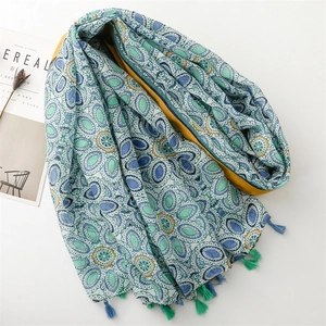 Bohemian geometric print scarf with blue and green tassels and a yellow inner lining