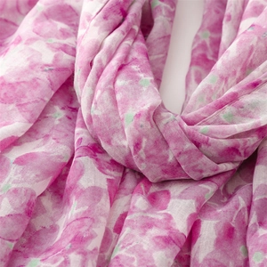 Close-up of pink floral scarf showing soft translucent chiffon texture and watercolor print