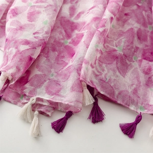 Detail of pink floral scarf showing texture with off-white and purple fringe tassels