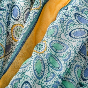 Detailed view of bohemian floral pattern on lightweight summer scarf with yellow edges