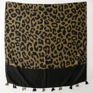 Close-up of leopard print twill scarf with black and army green tassel fringe detail