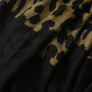Close-up of leopard print twill fabric texture with soft drape and refined weave details