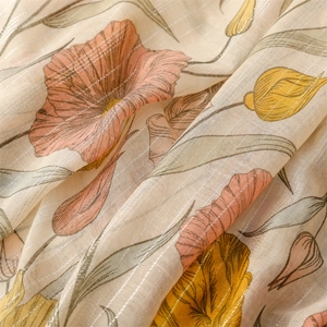 Close-up of cotton-linen feel scarf with yellow floral print and shiny silver lurex threads