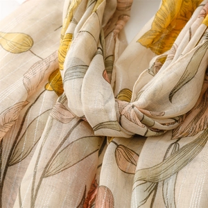 Detail of floral tulip scarf with metallic silver stripes and soft linen texture