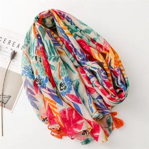 Chic cotton-linen feel scarf with colorful parrot leaf print and orange tassels