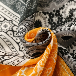 Macro shot of yellow paisley pattern on herringbone weave cotton scarf with soft texture