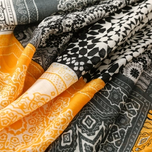 Macro view of geometric mandala patterns and herringbone texture on the yellow shawl