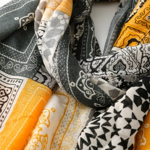 Detail of bohemian geometric scarf with paisley patterns and herringbone texture