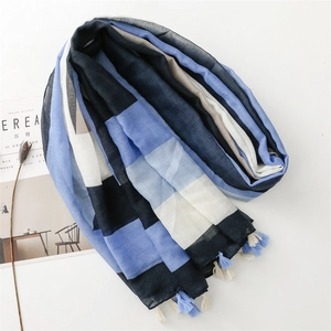 Detailed close-up of geometric color-block scarf with soft cotton-linen texture and tassels
