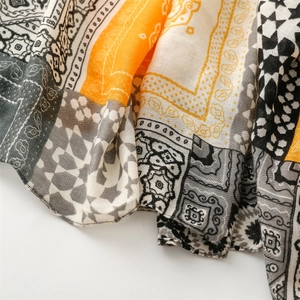 Detail of bohemian scarf showing yellow herringbone texture and geometric patterns