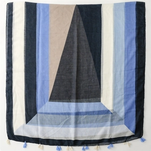 Detail of multi-color geometric cotton scarf with soft fringes and blue accents