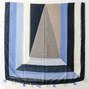 Detailed close-up of geometric color block scarf with fine tassel fringe edges