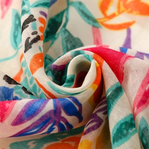 Macro view of lightweight breathable cotton linen scarf with colorful parrot leaf patterns