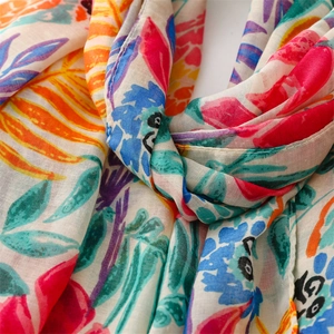 Close-up of lightweight cotton linen scarf showing colorful parrot leaf print texture